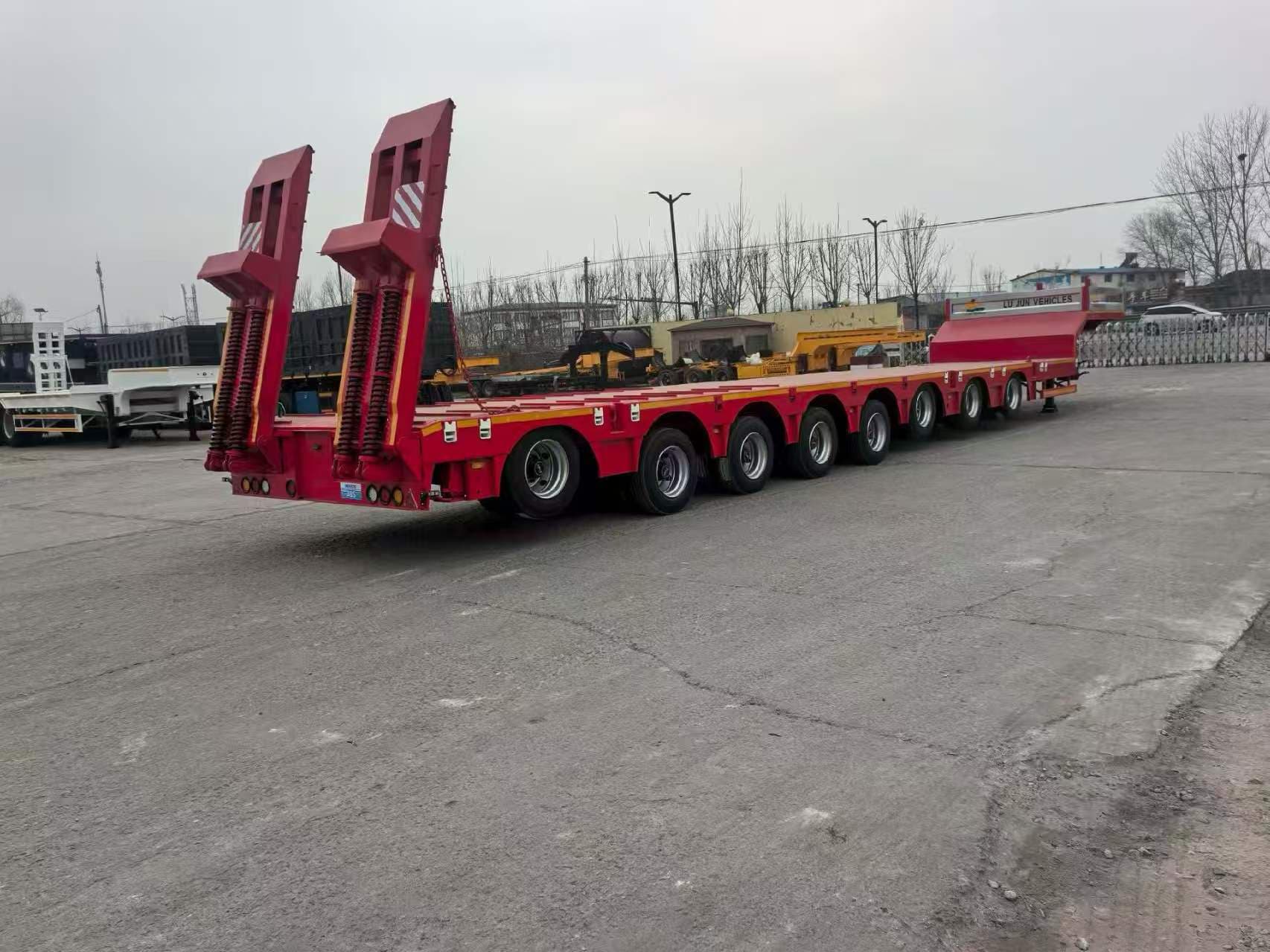 Multi-axle lowbed equipment trailer photographed in a supplier yard